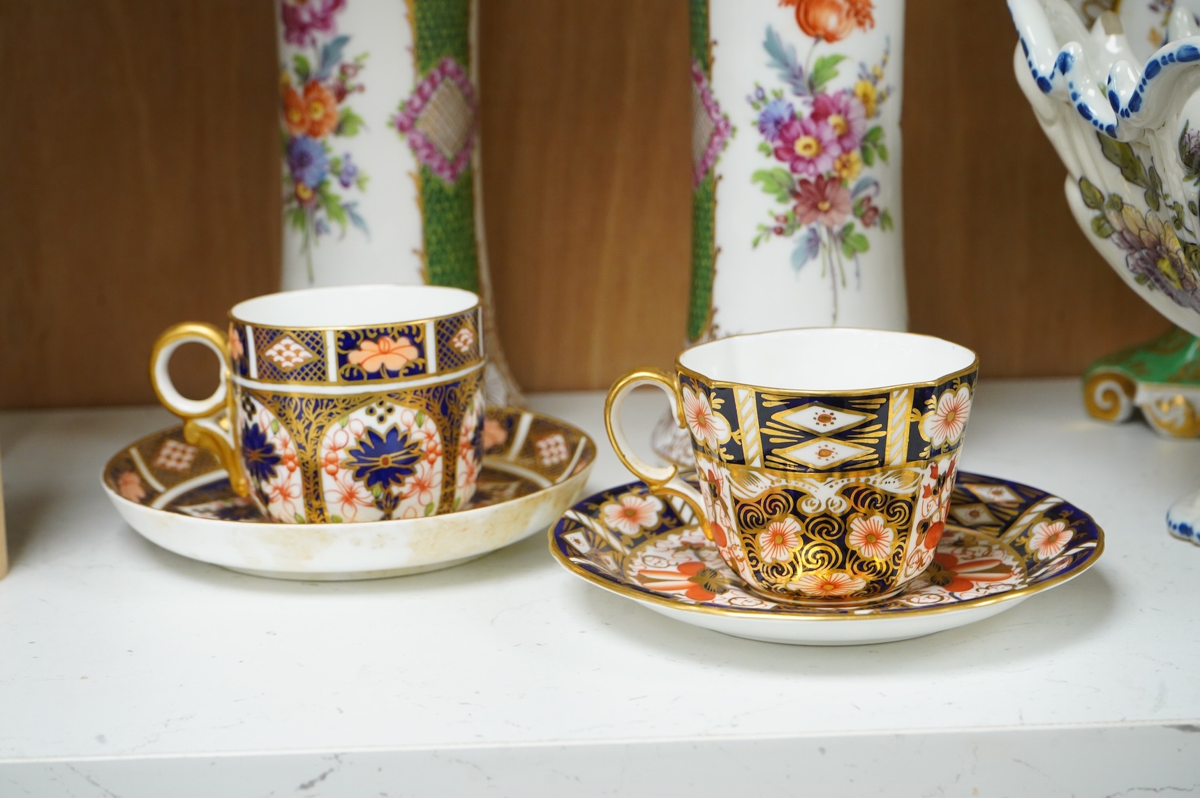A pair of Dresden vases, a Paris porcelain bottle and stopper, a faience bowl and two Royal Crown Derby cups and saucers, tallest 26cm
